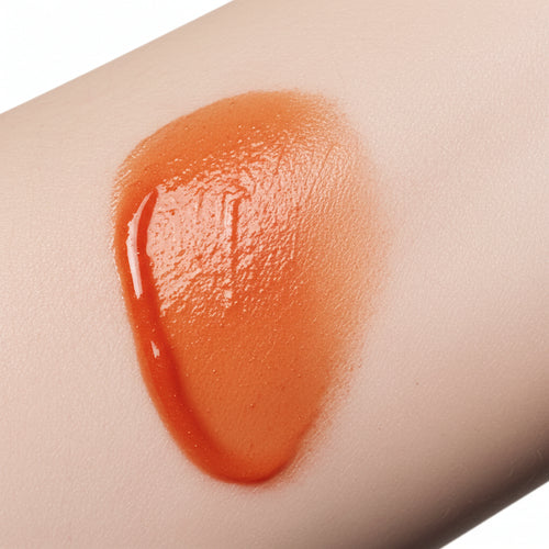 Natural skin swatch of Kalee Beauty Burnt Orange 2-in-1 Lip Oil & Cheek Tint showing sheer, dewy pigment on skin tone.