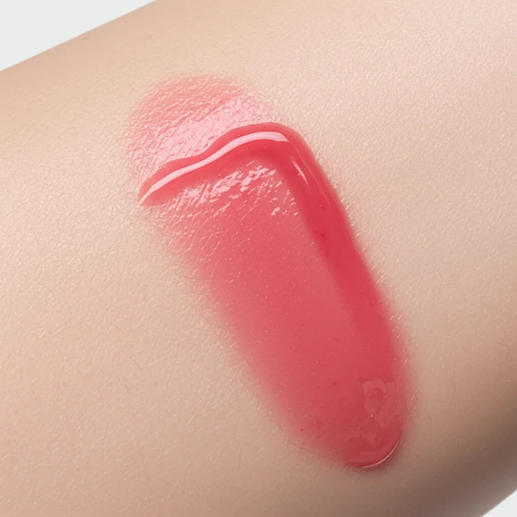 Natural skin swatch of Kalee Beauty Pink 2-in-1 Lip Oil & Cheek Tint showing sheer, dewy pigment on skin tone.