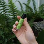 Hand holding the Sativa Kiss Lip Serum to show portable, travel-friendly sizing. Artisanal beauty handmade in small batches.